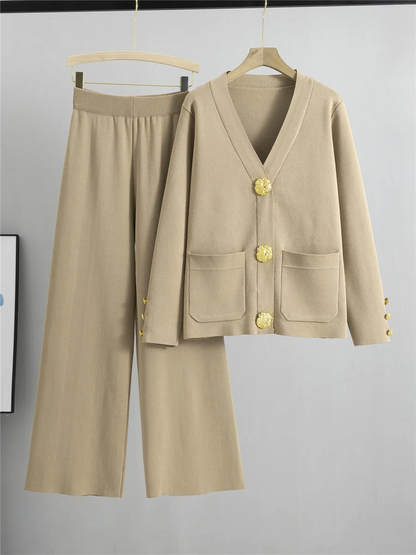 Sophisticated blue women's two-piece outfit featuring a gold trim cardigan and elegant wide-leg pants.