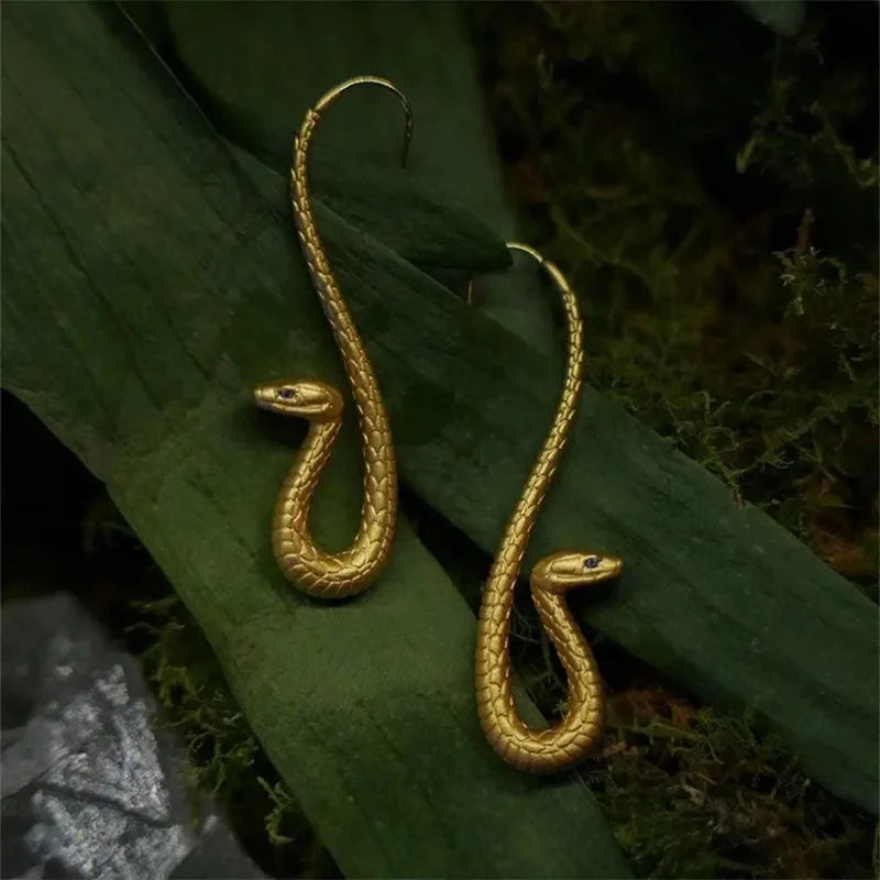 Luxurious golden serpent dangle earrings for women, an elegant and unique jewelry fashion accessory.