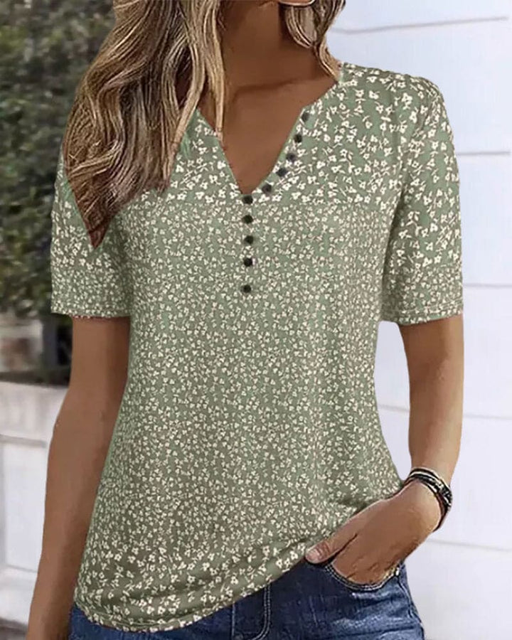 Elegant women's green floral summer shirt with short sleeves, perfect for spring casual wear or a vacation outfit.