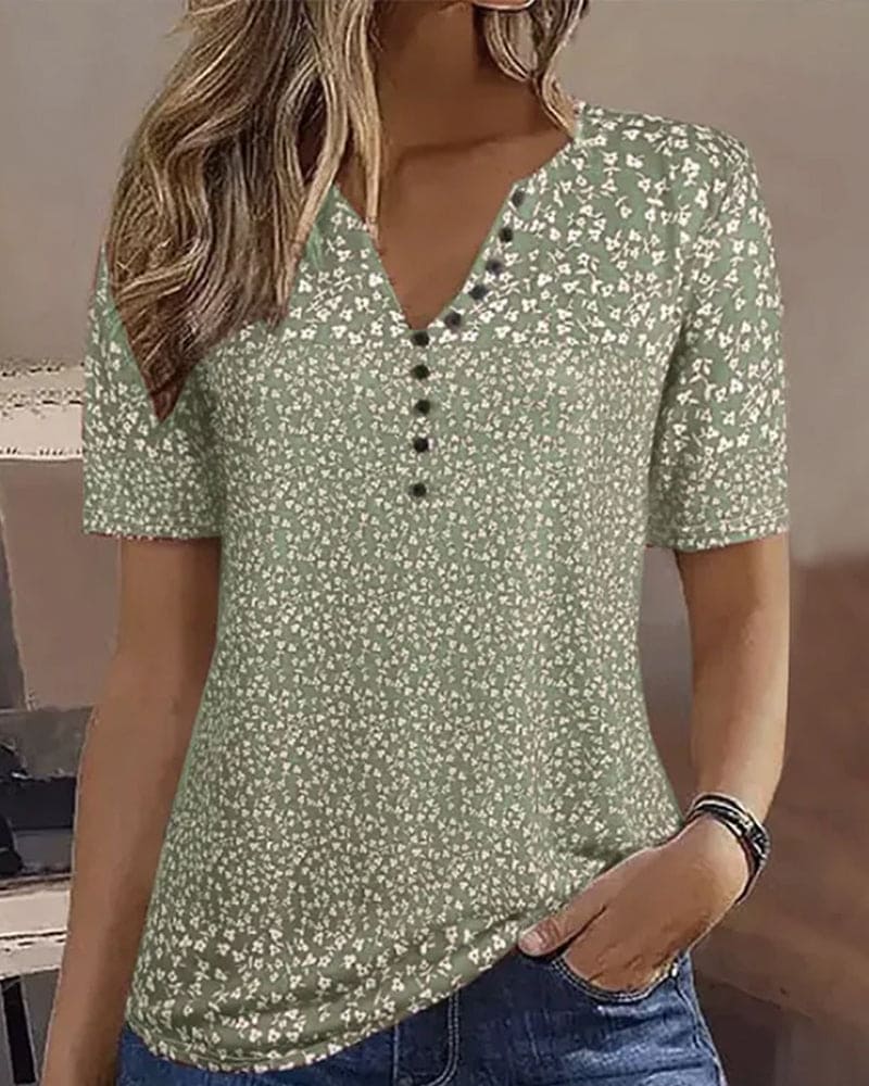 Relaxed fit women's green floral short-sleeve blouse, an elegant summer top for casual wear or vacation style.