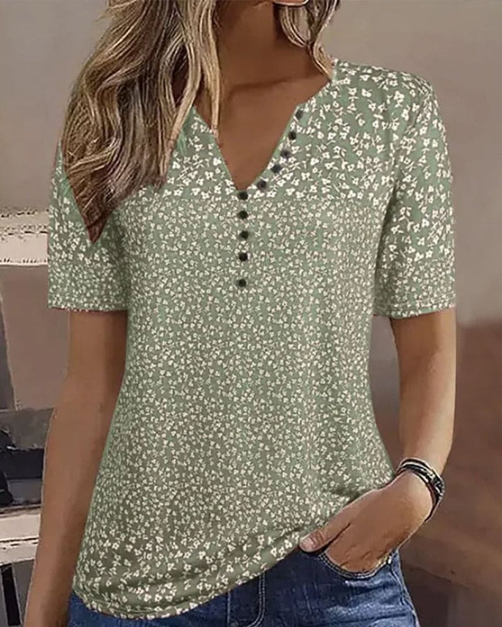 Relaxed fit women's green floral short-sleeve blouse, an elegant summer top for casual wear or vacation style.