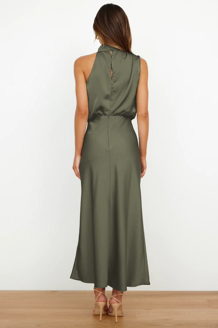 Flowing fabric of a women's floor-length halter evening gown, perfect for a sophisticated look.