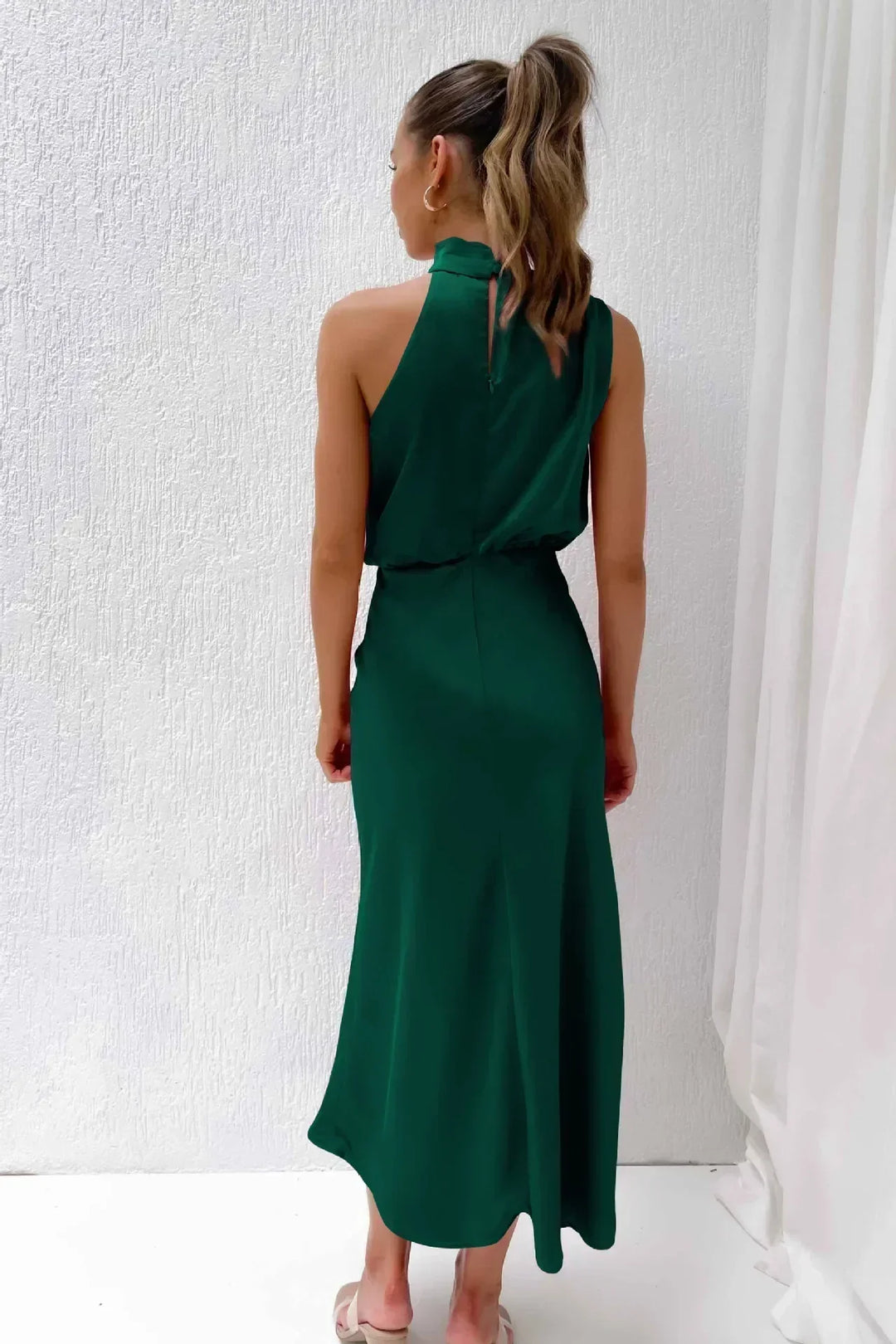 Timeless women's floor-length halter dress, an elegant open-back evening gown for formal events.