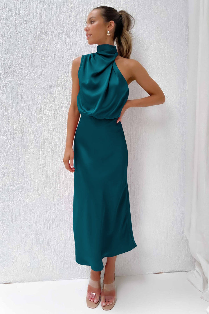 Women's wedding guest dress: sophisticated floor-length halter gown with an open back.
