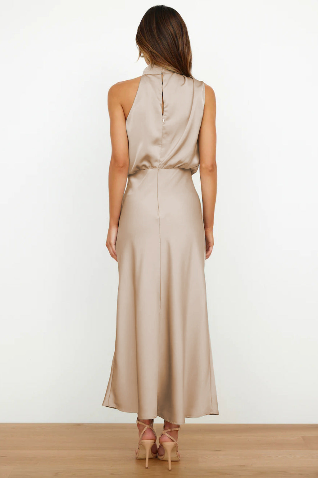 Front view: Elegant women's halter neck evening dress with a flowing, floor-length skirt.