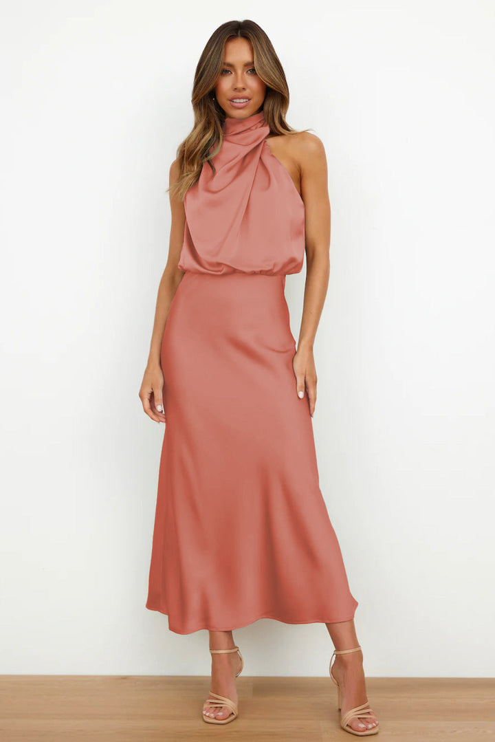 Back view: Daring open-back halter evening gown, a sophisticated floor-length women's formal dress.