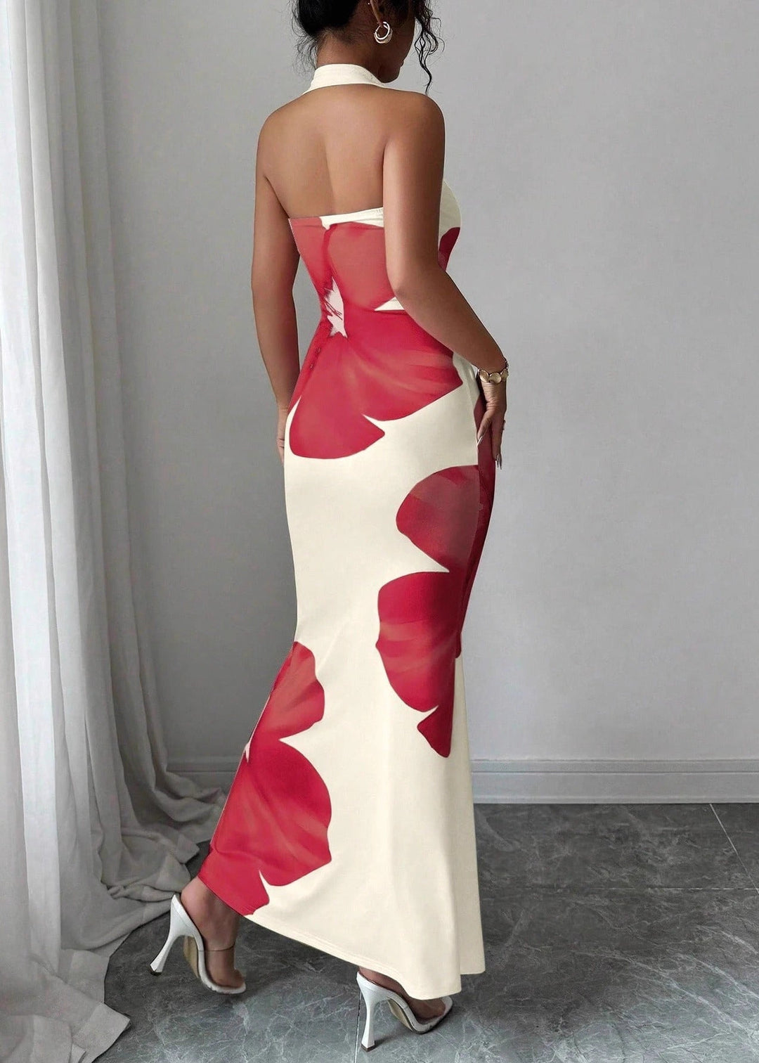 Red halter maxi dress with a striking floral print, designed for sophisticated women's occasion wear.