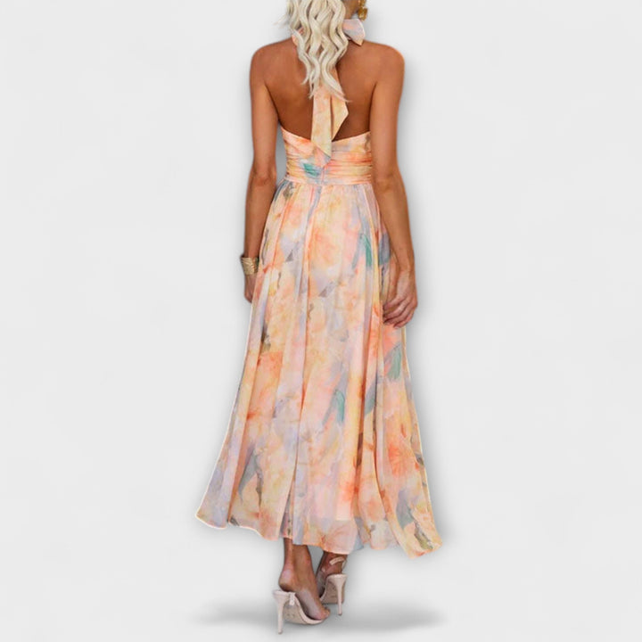 Flowy halter maxi dress for women, featuring a chic open back, ideal for elegant summer events & occasion wear.