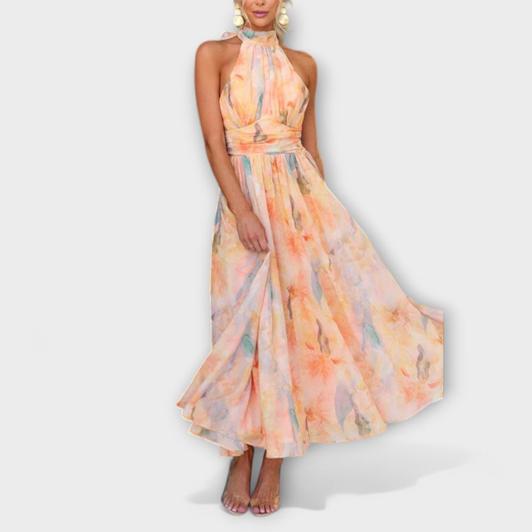 Women's stylish halter maxi dress with beautiful watercolor print & elegant open back, a fashionable summer outfit.