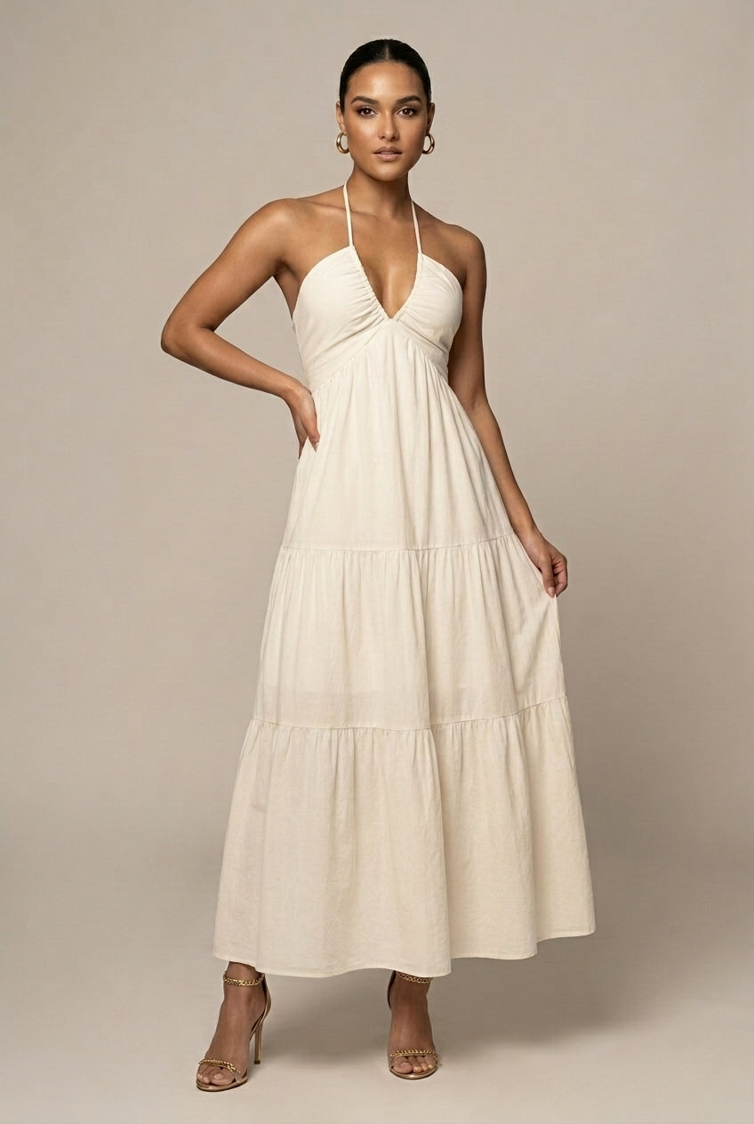 Elegant women's halter neck maxi dress with tiered ruffle skirt & open back. Perfect for summer events & wedding guests.