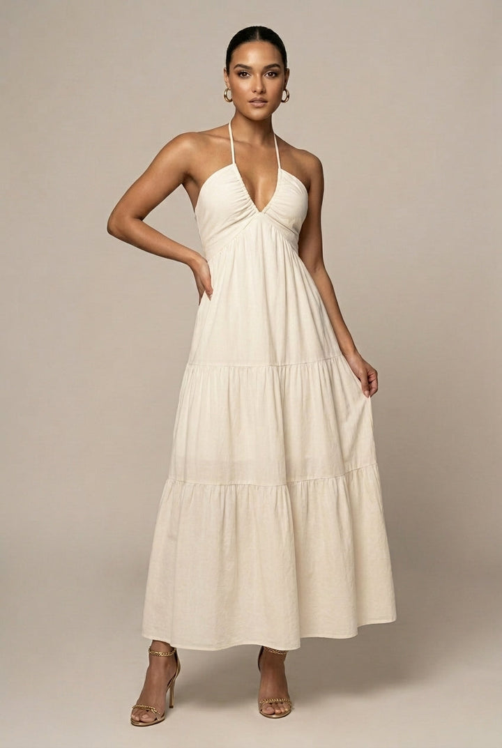 Elegant women's halter neck maxi dress with tiered ruffle skirt & open back. Perfect for summer events & wedding guests.