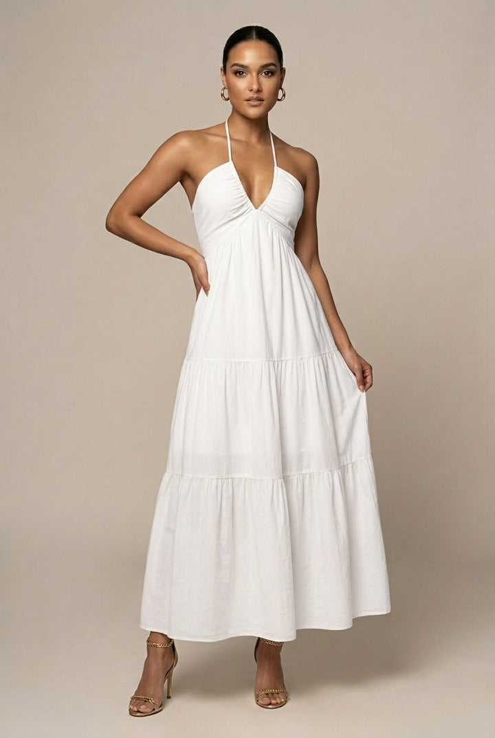 Chic women's halter neck maxi dress featuring a detailed tiered ruffle skirt and elegant open back.