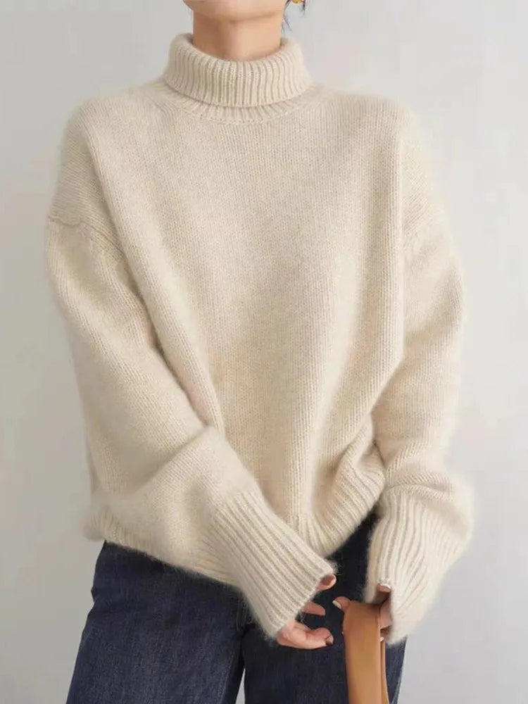 Versatile beige women's high-collar sweater, a cozy long-sleeve top for elegant fall & winter styles.