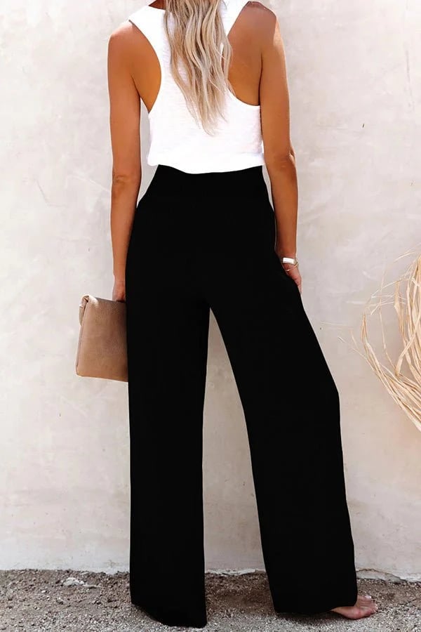 Women's black high-waisted tailored trousers with a smocked waist, blending elegance with ease.