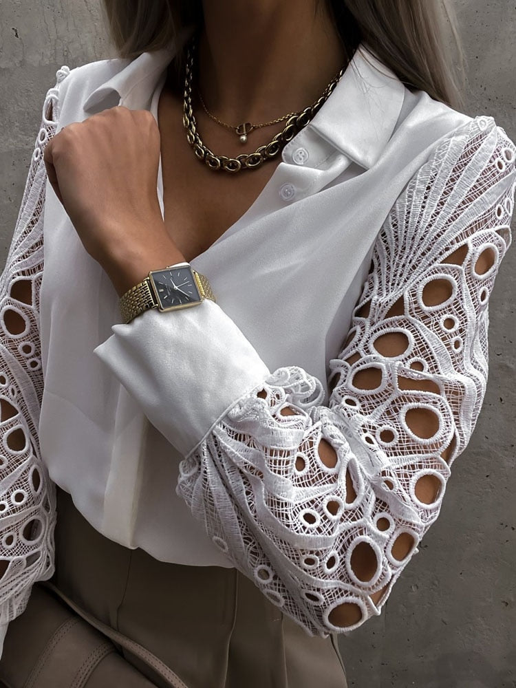 Fashionable white hollow out blouse for women. Elegant long sleeve top, perfect for a chic casual look.