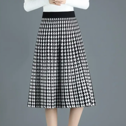 Classic houndstooth print midi skirt for women, elegantly pleated A-line with a flattering high-waist. Chic fall fashion.