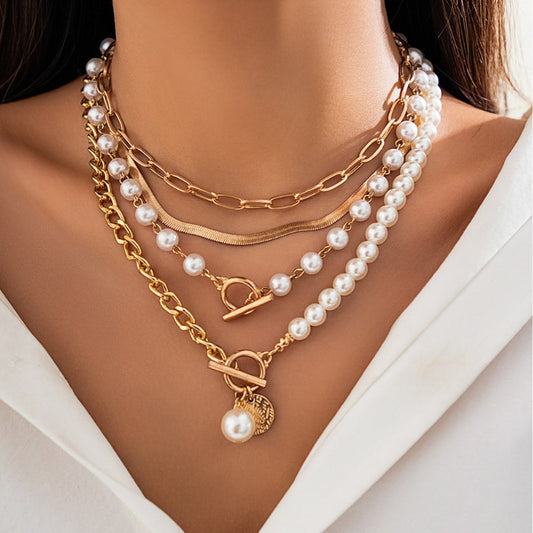 Elegant women's layered necklace featuring lustrous pearls and delicate gold chains, perfect fashion jewelry.