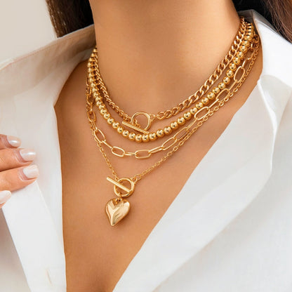 Women's chic layered necklace with white pearls and gold-tone chains, a versatile fashion accessory.