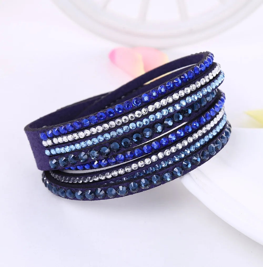 Close-up of a women's layered rhinestone bracelet, showcasing its elegant sparkle and detailed design.