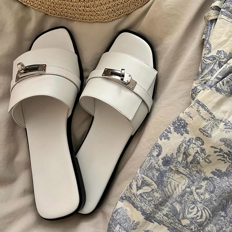Elegant women's leather square-toe slides with a metallic buckle, perfect for chic summer footwear.