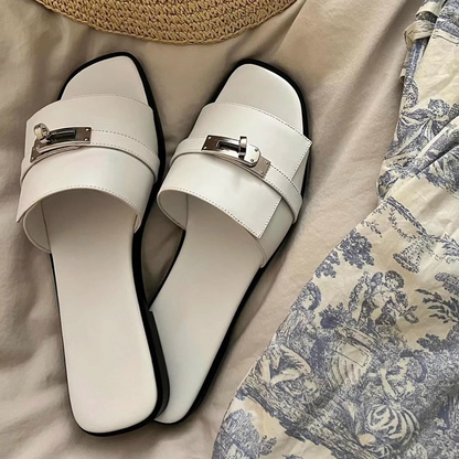 Elegant women's leather square-toe slides with a metallic buckle, perfect for chic summer footwear.
