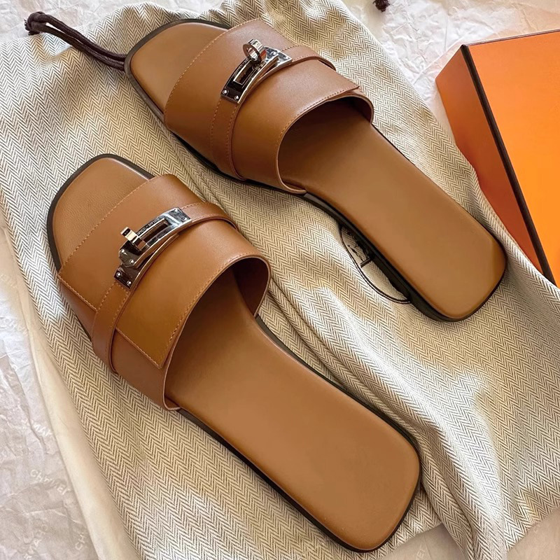 Chic women's leather square-toe sandals, designed as elegant slides with a stylish metallic buckle detail.