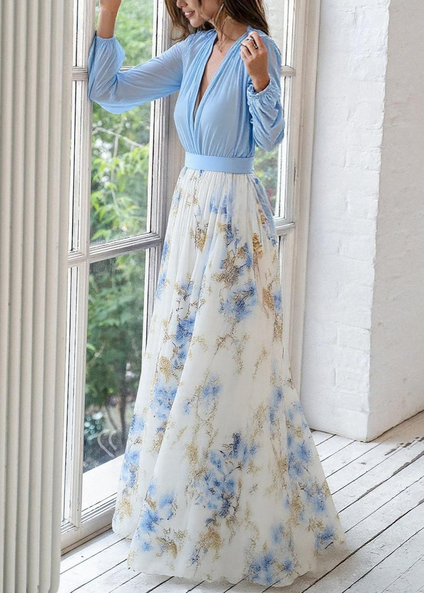 Flowing women's maxi dress featuring a vibrant floral print and elegant long sleeves with a deep V-neck.