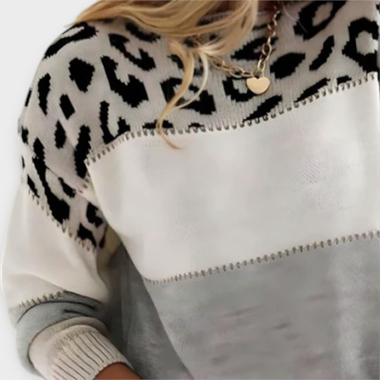 Chic gray women's knit sweater featuring an elegant panther print. Ideal for stylish cold weather fashion.