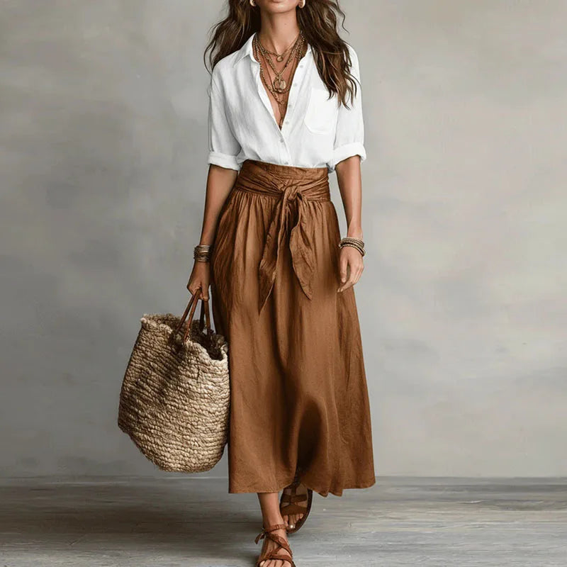 Stylish women's long sleeve co-ord set featuring a tie-waist skirt. Versatile two-piece outfit, ideal for casual wear or office attire.