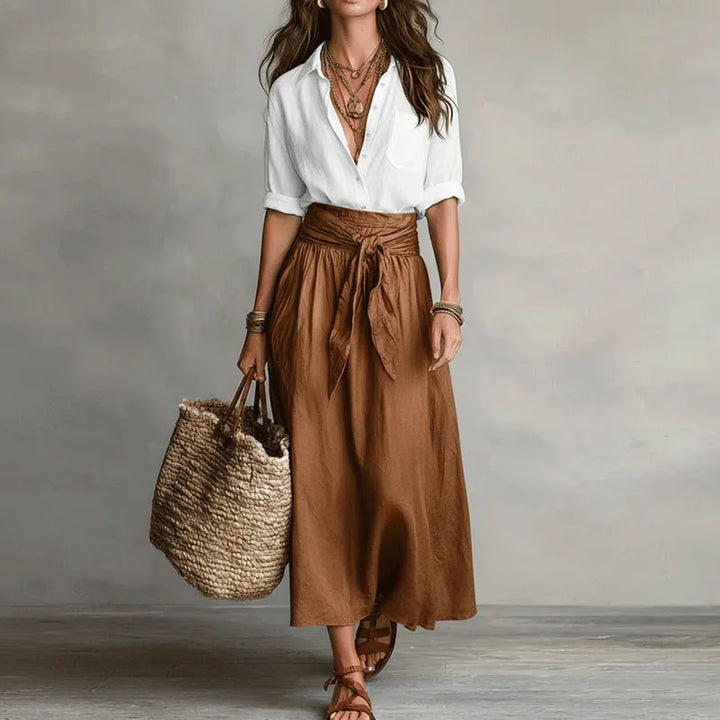 Stylish women's long sleeve co-ord set featuring a tie-waist skirt. Versatile two-piece outfit, ideal for casual wear or office attire.