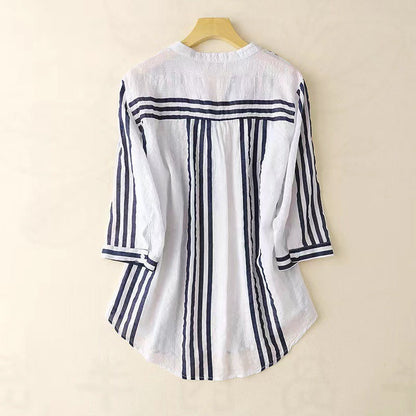 Versatile women's striped button-down shirt. Sophisticated long sleeve top for casual or professional wear. Summer fashion.