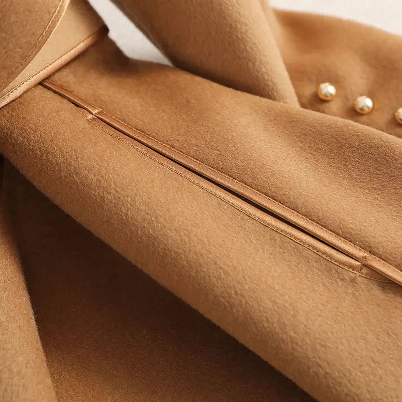 Tailored women's long trenchcoat with a chic belted waist, ideal for sophisticated formal or casual outerwear.
