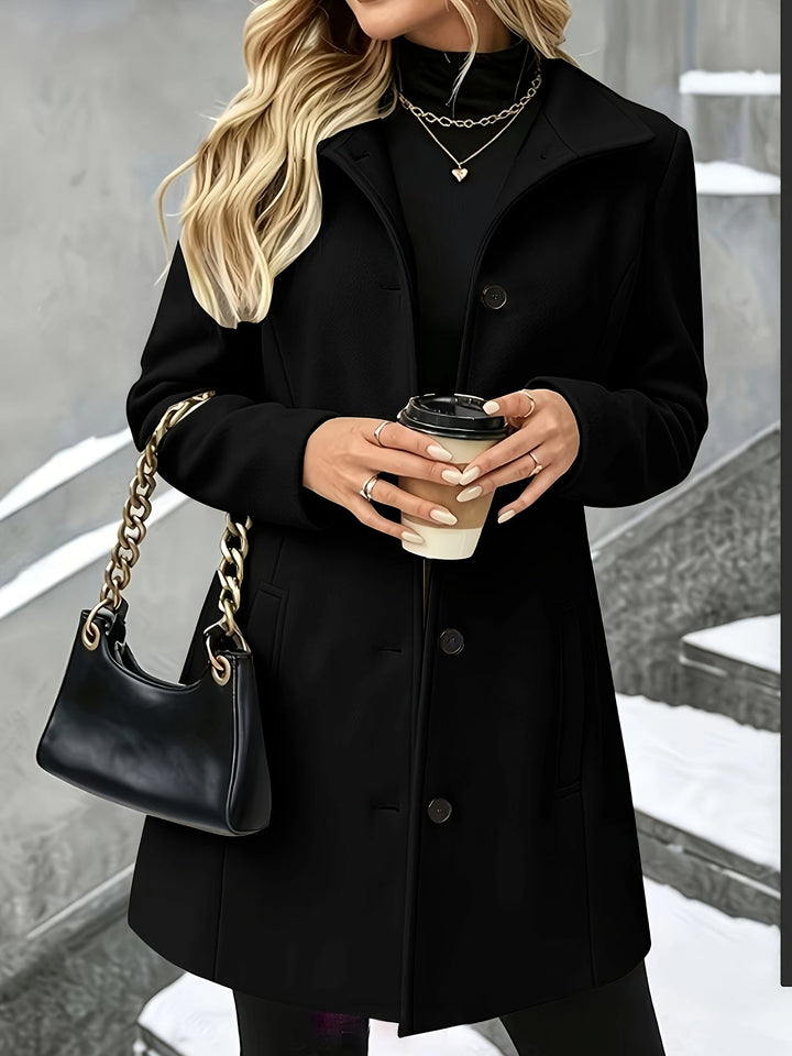 Longline women's single-breasted coat with an elegant notch collar, a classic piece of outerwear.