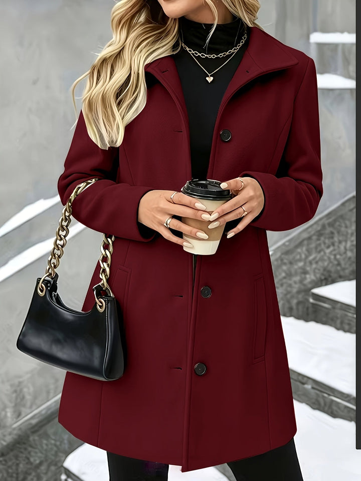 Tailored women's longline winter coat, single-breasted and chic with a prominent notch collar.