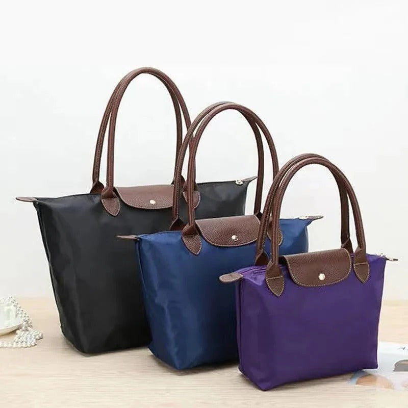 Beautiful women's luxury handle bag. Elegant top carry purse, a chic and practical fashion accessory.