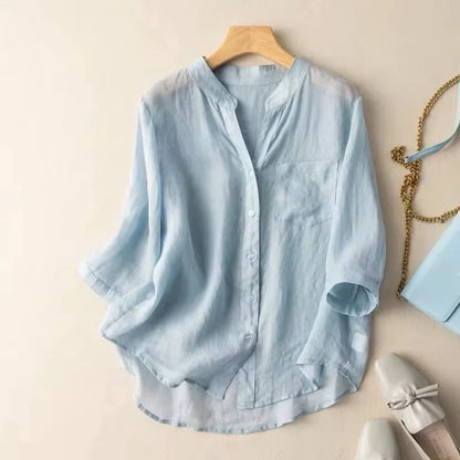 Relaxed fit women's mandarin collar blouse with stylish long sleeves and practical pocket detail for comfort.
