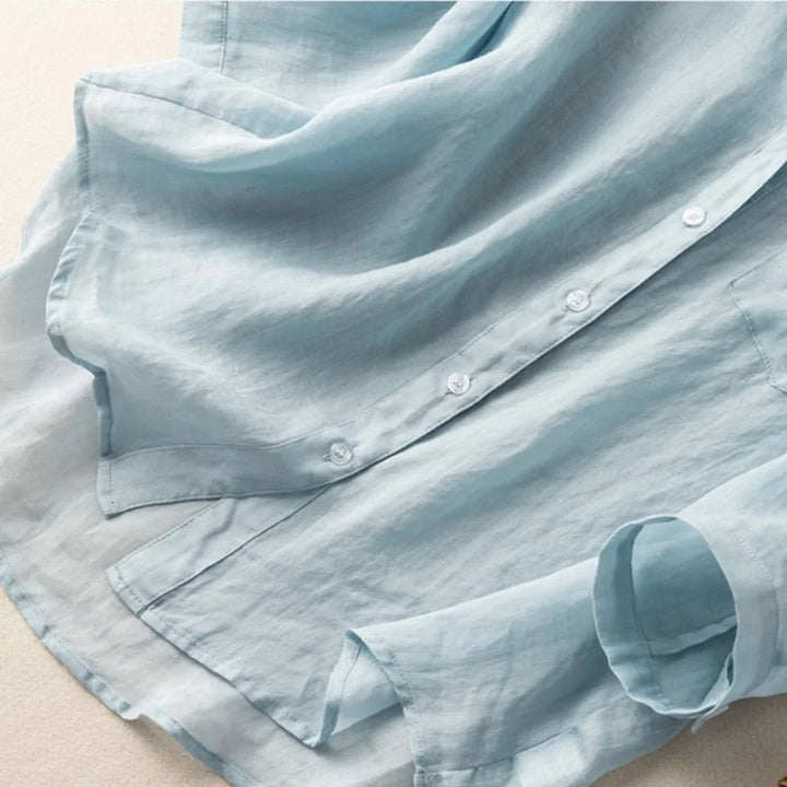 Chic women's mandarin collar blouse, featuring elegant long sleeves and a subtle pocket detail. Versatile top.