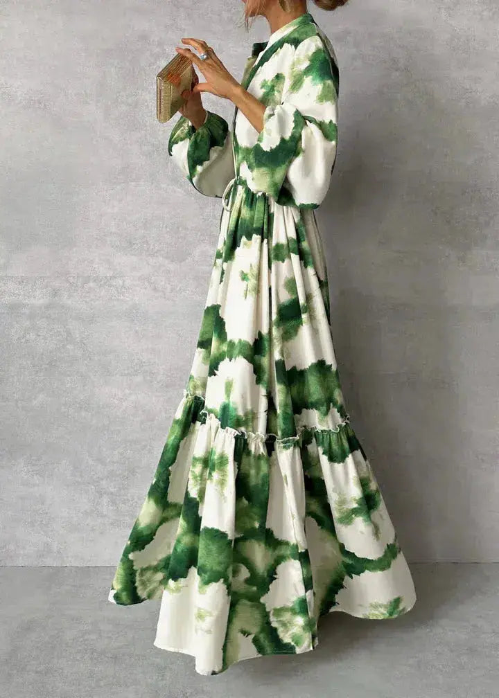Sophisticated long formal dress for women, ideal for wedding guests & evening wear, featuring puff sleeves & tiered skirt.