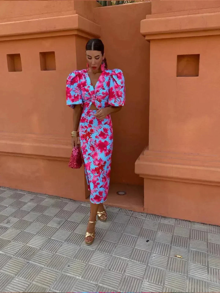 Stylish women's printed maxi dress featuring a V-neck, elegant puff sleeves, and a flattering ruched waist. Ideal for guests.