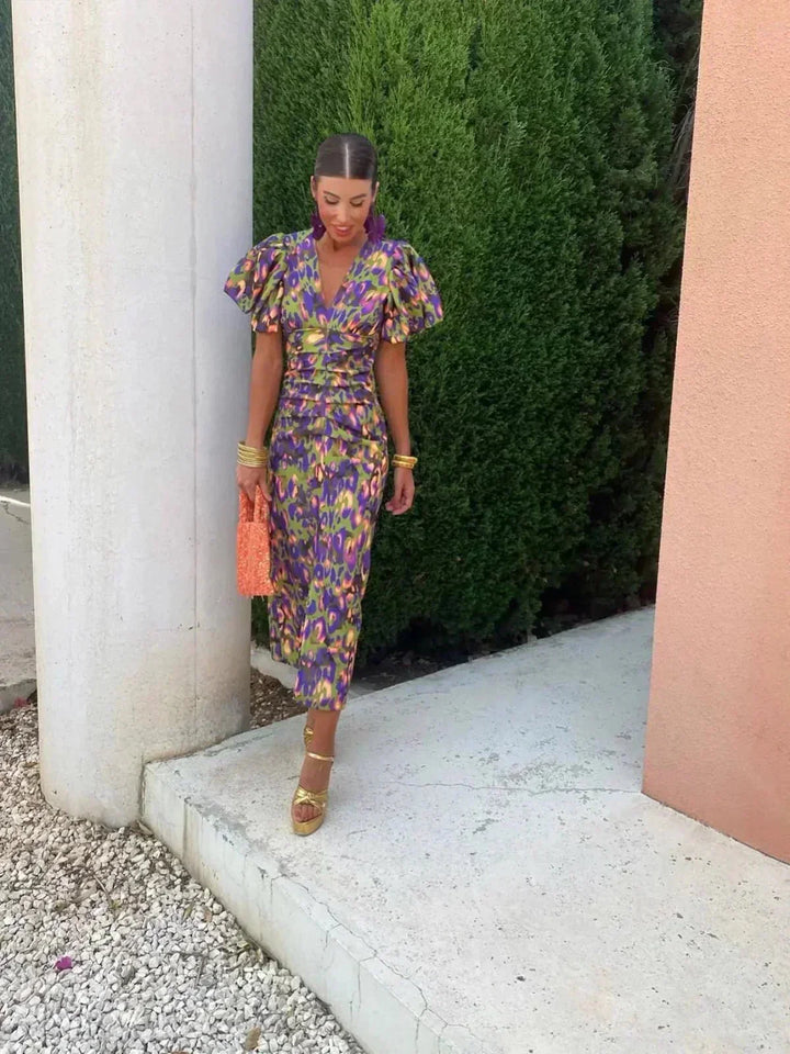 Chic abstract print maxi dress for women, perfect as a wedding guest or special occasion evening dress. V-neck, puff sleeves.
