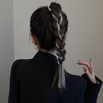 Stylish women's hair clip crafted from metal, featuring elegant flowing tassels. A fashionable accessory.