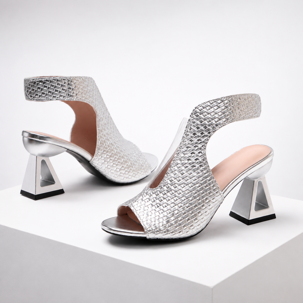 Women's elegant open-toe heels, metallic weave upper, and a striking geometric heel, perfect for events.