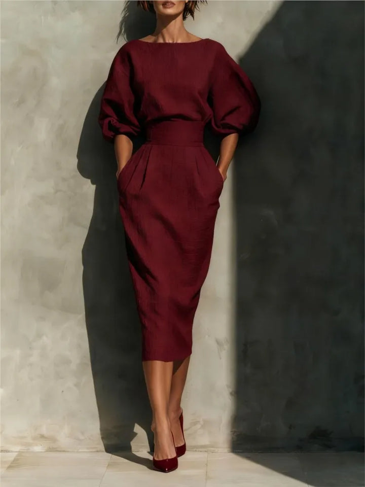 Sophisticated pleated midi dress for women featuring a cinched waist & stylish lantern sleeves, versatile fashion.