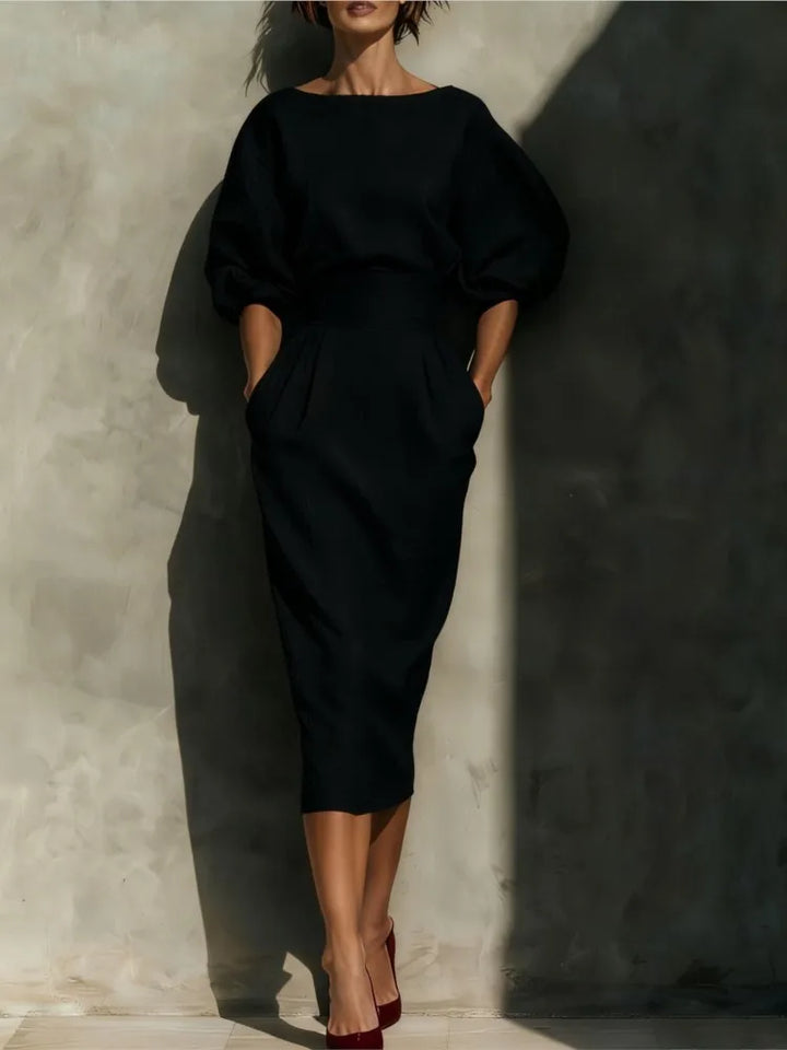 Modern elegant women's midi dress with intricate pleats, long lantern sleeves, and a chic wrap skirt design.