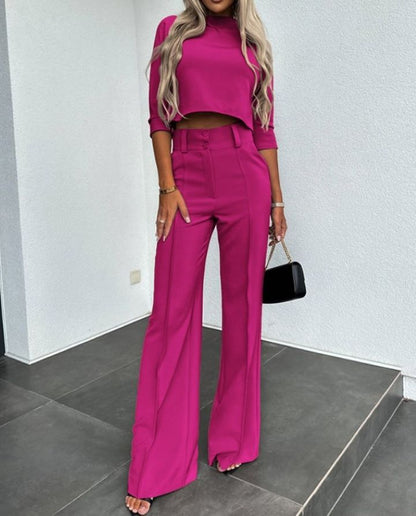 Modern elegant two-piece women's clothing set, featuring chic wide-leg pants and a stylish top for a polished look.