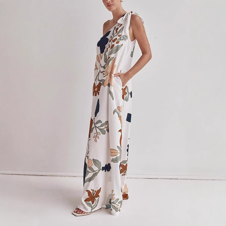 Flowy one-shoulder maxi dress for women with vibrant floral print, ideal for beach, resort, or summer events.