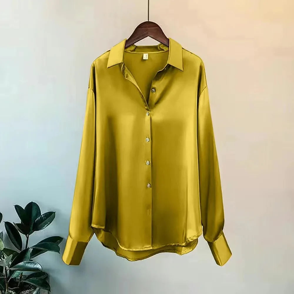 Women's elegant oversized button-down shirt. Long-sleeve blouse, styled for a chic workwear or polished casual outfit.