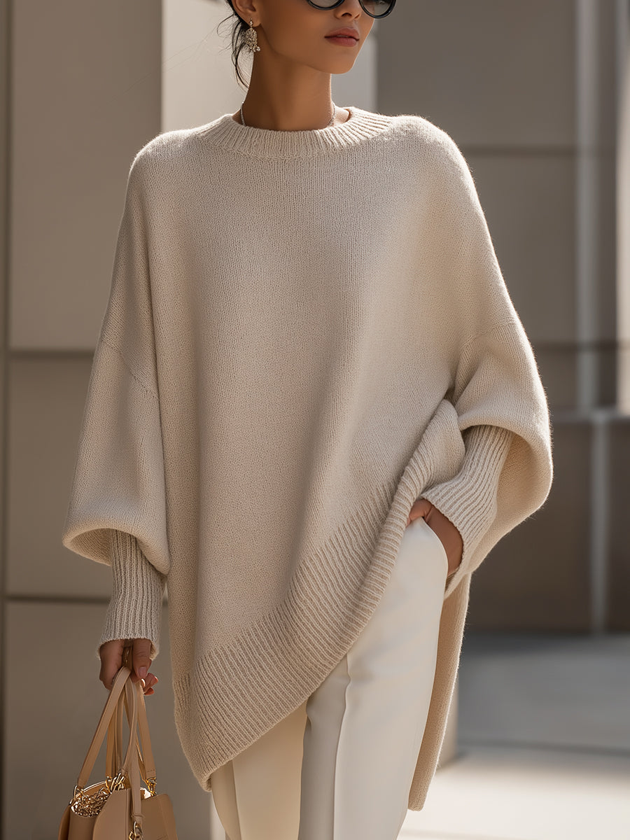 Elegant women's oversized cape sweater. Soft poncho style knit with draped batwing sleeves.