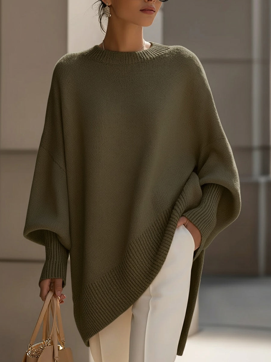 Versatile women's elegant sweater. Oversized cape poncho with batwing sleeves. Cozy autumn fashion.