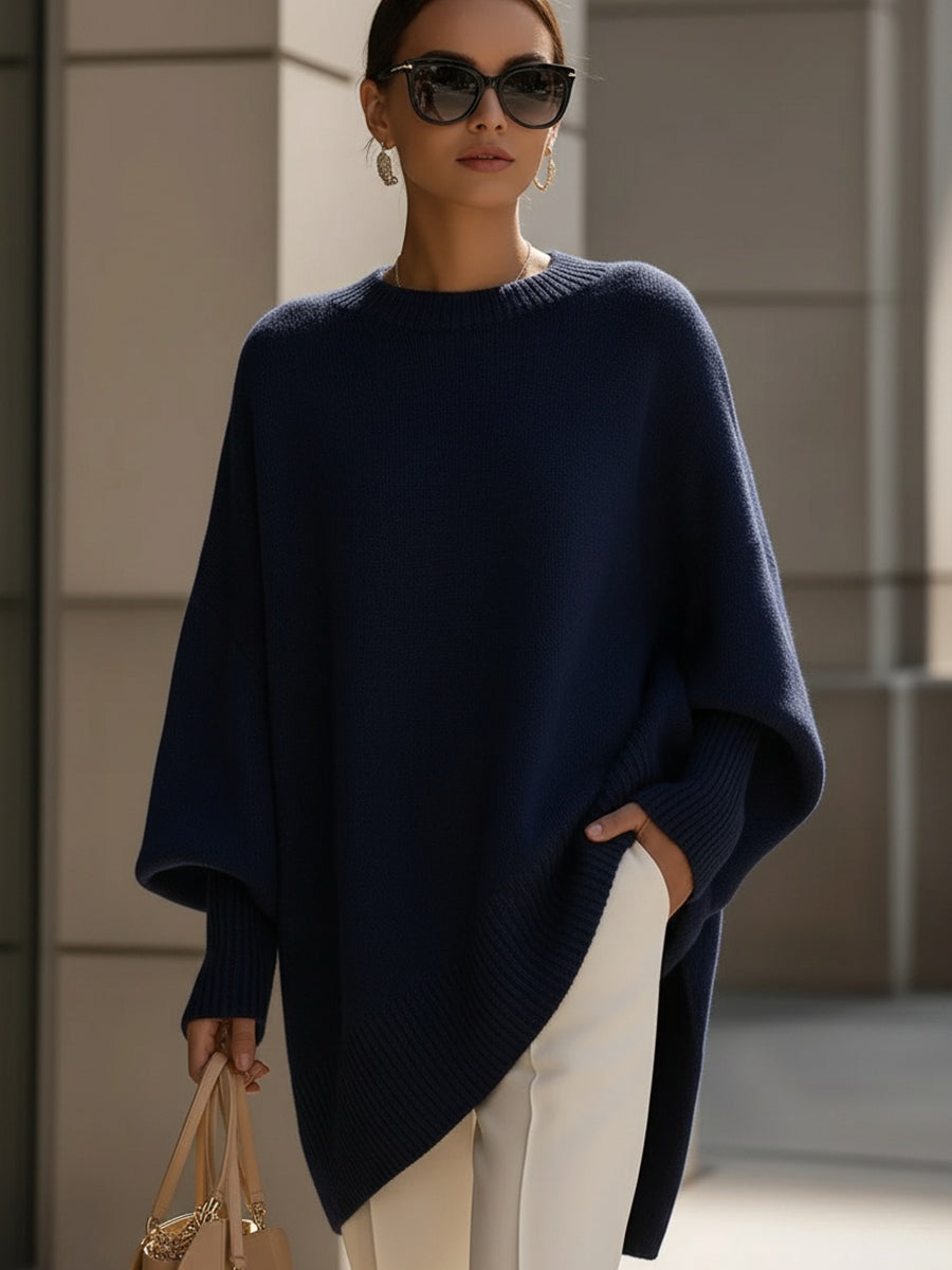Draped women's oversized sweater. Elegant poncho style with cozy batwing sleeves. Autumn fashion.